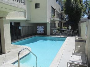 Sherman Oaks apartment for rent - a swimming pool in front of an apartment building