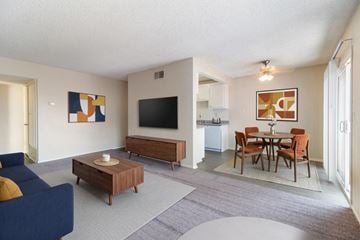 Upland apartment for rent - A living room with a blue couch and a wooden coffee table.
