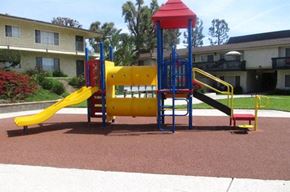 Upland apartment for rent - a playground with a yellow and blue swing set