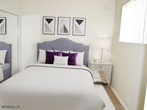 Pasadena apartment for rent - A bedroom with a large bed and a nightstand with a lamp.