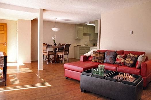 Orange apartment for rent - a living room with a red couch and a table