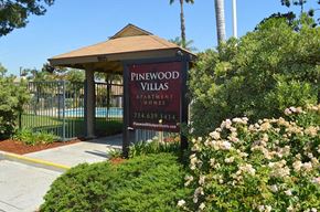Orange apartment for rent - a sign for pinewood villas in front of a gazebo