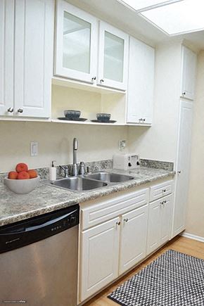 Burbank apartment for rent - a kitchen with white cabinets and a sink and a dishwasher