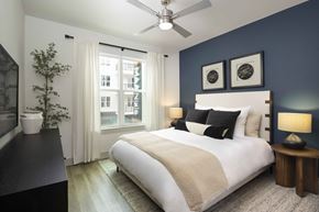 Durham apartment for rent - Stylish primary bedroom with large bright windows and elegant furniture at MAA Nixie Luxury apartments in Durham, NC