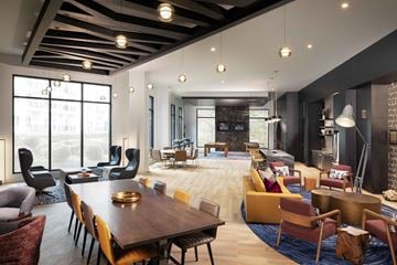 Durham apartment for rent - A modern living room with a large wooden table and comfortable seating.