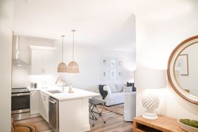 Santa Rosa Beach apartment for rent - a kitchen and living room with white walls and wood floors
