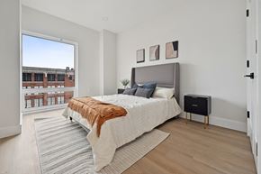 Jersey City apartment for rent - a bedroom with a large bed and a large window