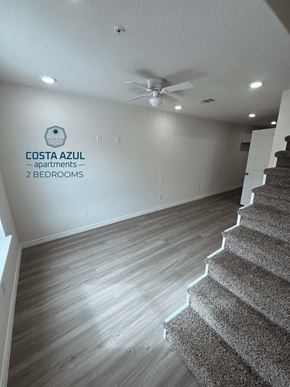 San Antonio apartment for rent - a living room with a staircase and a ceiling fan