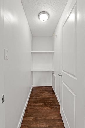 Calgary apartment for rent - A long hallway with a light on the ceiling and a door on the right.