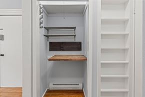 Philadelphia apartment for rent - A white pantry with a door open to a white shelving unit.