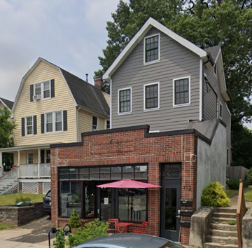 Montclair apartment for rent - A grey house with a red umbrella in front.