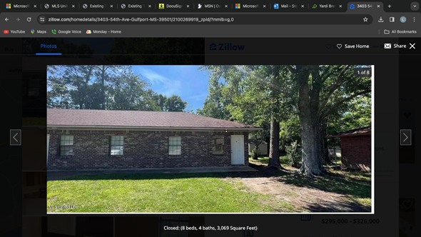Gulfport apartment for rent - A brick house with a white door and a tree in front.