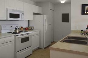 Kissimmee apartment for rent - a kitchen with white appliances and a sink