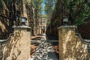 Chicago apartment for rent - a pathway between two brick pillars and trees