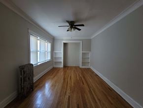 Chicago apartment for rent - a living room with wood floors and a ceiling fan