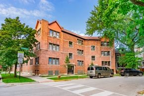 Chicago apartment for rent - a large brick building with a van parked in front of it