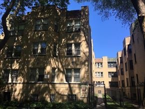 Chicago apartment for rent - a tall building with a tree in front of it