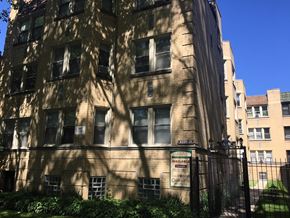Chicago apartment for rent - an old building with a fence in front of it