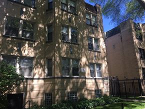 Chicago apartment for rent - the exterior of a brick apartment building with shadows on it