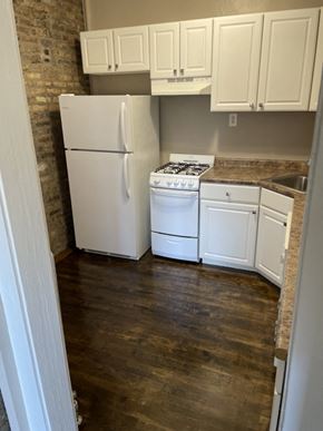 Chicago apartment for rent - a kitchen with white appliances and white cabinets