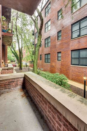 Chicago apartment for rent - the view of a brick apartment building from the sidewalk
