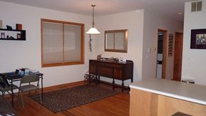 Chicago apartment for rent - a dining room and living room with a table and a dresser