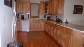 Chicago apartment for rent - a kitchen with wooden cabinets and white appliances
