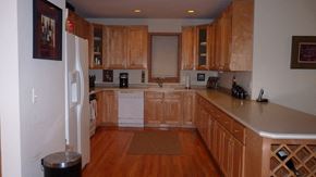 Chicago apartment for rent - a kitchen with wooden cabinets and a white refrigerator