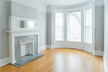 Chicago apartment for rent - a living room with a fireplace and a wooden floor