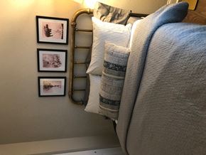 Chicago apartment for rent - a bed with pillows and pictures on the wall