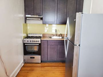 Evanston apartment for rent - a small kitchen with a stove and a refrigerator
