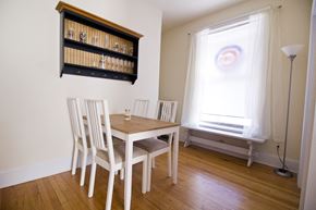 Chicago apartment for rent - a dining room with a table and chairs and a window