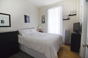 Chicago apartment for rent - a bedroom with a bed and a television