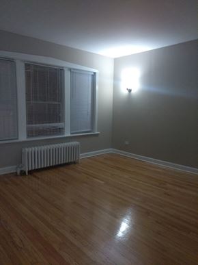 Chicago apartment for rent - the living room of a house with a wood floor and a window