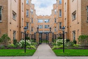 Chicago apartment for rent - a sidewalk in front of a brick building with a gate