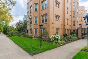 Chicago apartment for rent - a sidewalk in front of a brick apartment building