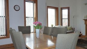 Chicago apartment for rent - a dining room with a wooden table with flowers on it