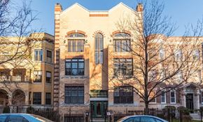 Chicago apartment for rent - a large brick building with cars parked in front of it