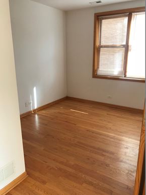 Chicago apartment for rent - an empty room with wooden floors and a window