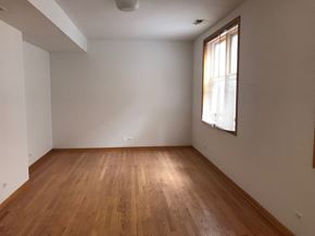 Chicago apartment for rent - an empty room with wooden floors and a window