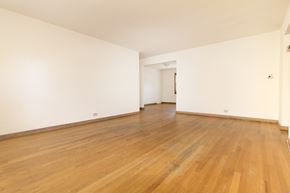 Skokie apartment for rent - an empty room with wooden floors and white walls