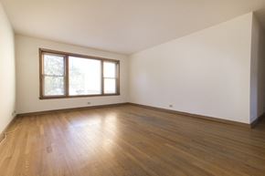 Skokie apartment for rent - an empty living room with wood floors and a window