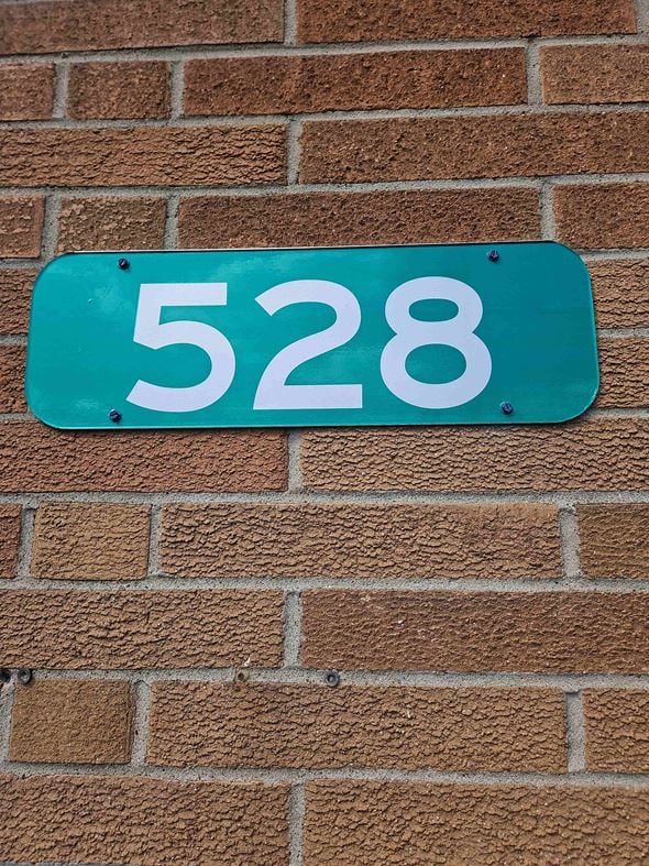 Niles apartment for rent - a blue sign with the number 5228 on a brick wall
