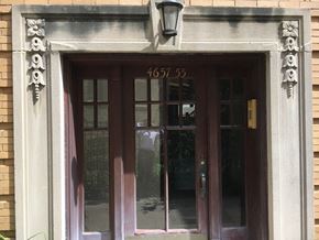 Chicago apartment for rent - the front door of a building with a clock on it