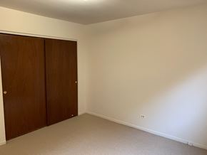 Skokie apartment for rent - a bedroom with a wardrobe and a carpeted floor