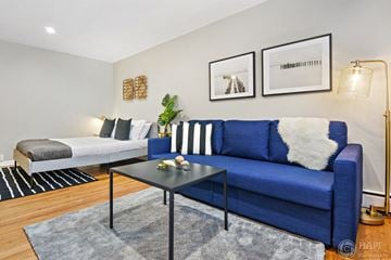 Chicago apartment for rent - a living room with a blue couch and a coffee table