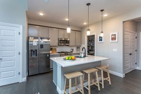 Colorado Springs house for rent - A kitchen with a refrigerator, microwave, and oven.