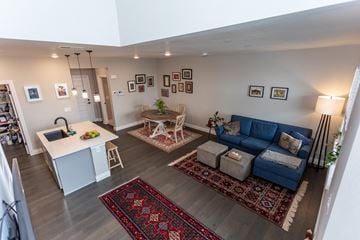 Colorado Springs house for rent - A living room with a blue couch and a rug.