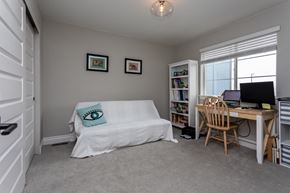 Colorado Springs house for rent - A room with a bed, desk, and chair.