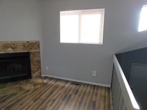 Fountain house for rent - A room with a fireplace and a window.